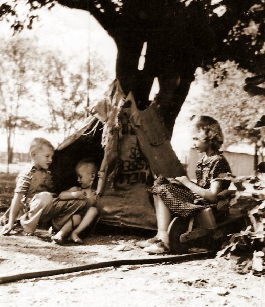 John, Jerry, Sophora beside their gunny sack tent, rigged up by Sherrill, 1946